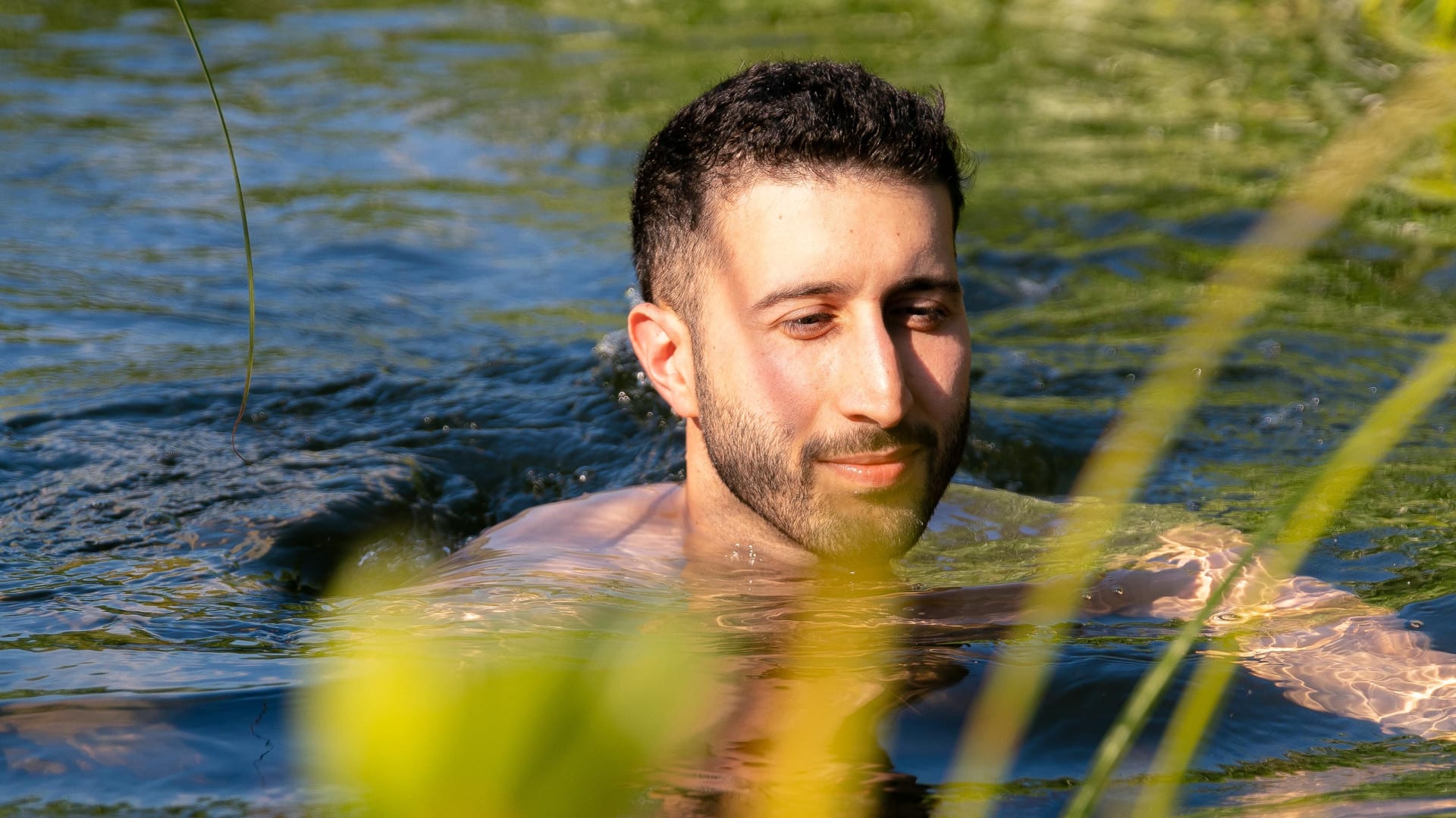 man in swimming pond