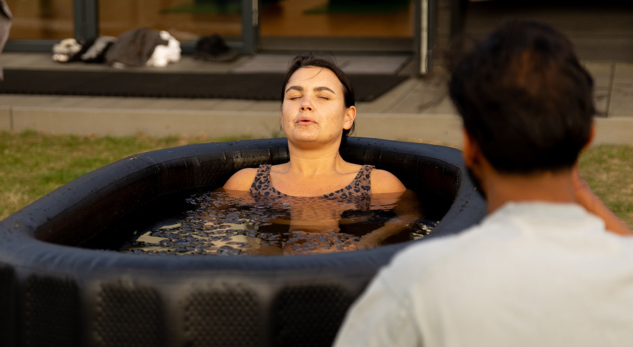 Guest guided through ice bath session at Glass House Wellness Retreat, focusing on breath and recovery.