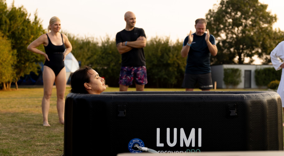 Group cold‑water therapy session at Glass House Wellness Retreat using LUMI recovery tubs outdoors.