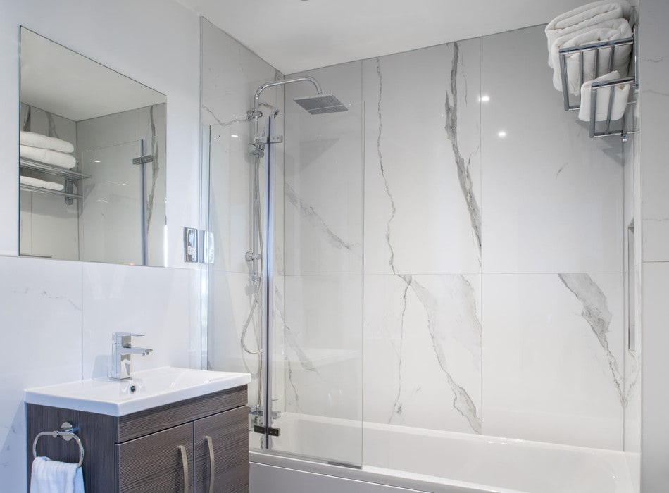 Shower over bath in bathroom