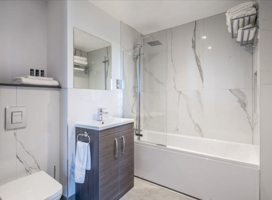 Shower over bath in bathroom