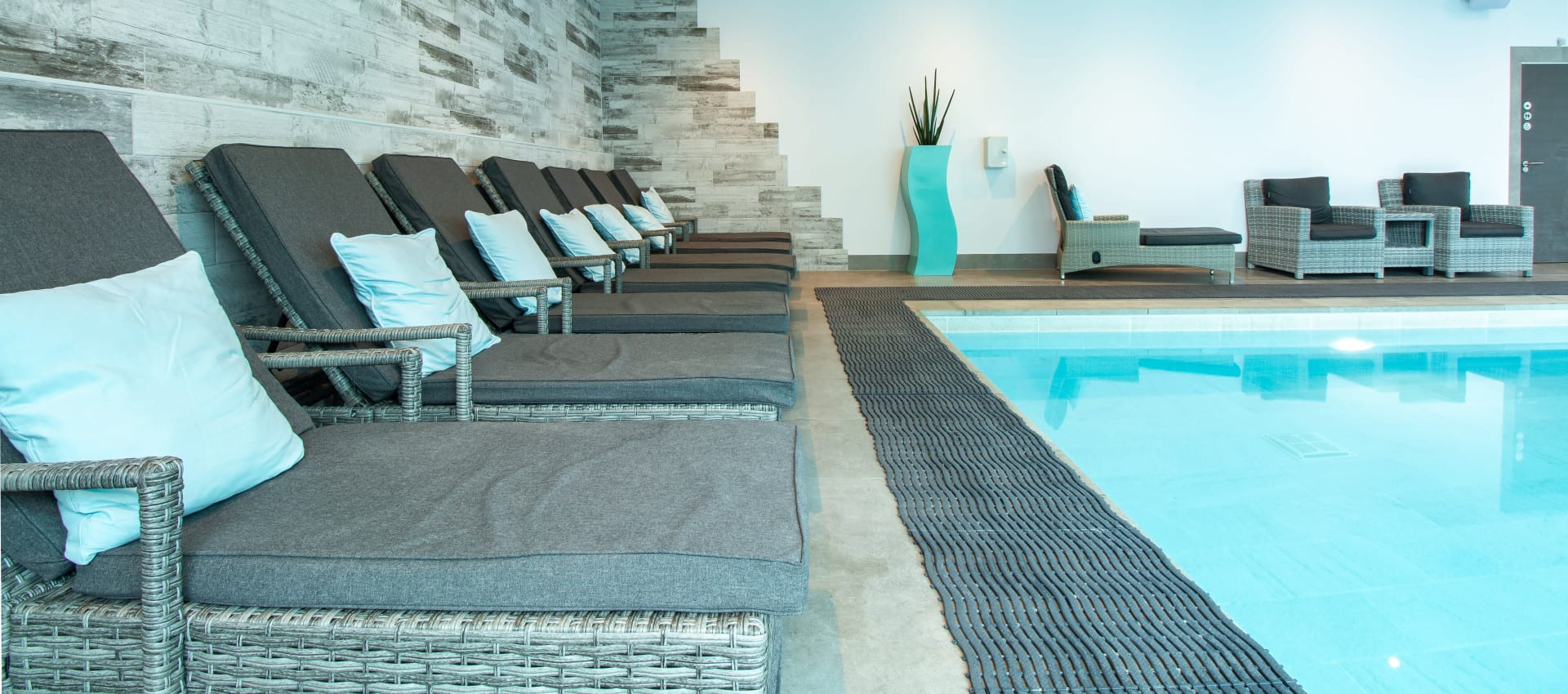 Loungers by indoor heated pool