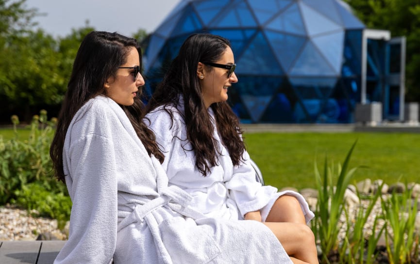 Two ladies sat by the pond